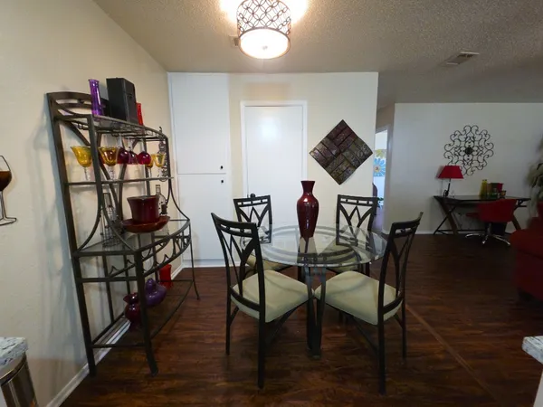 a view of a dining room with furniture and wooden floor