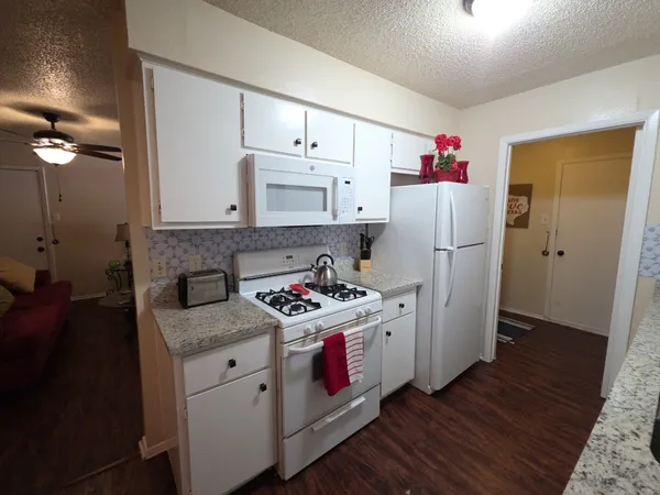 a kitchen with stainless steel appliances a stove a refrigerator and cabinets
