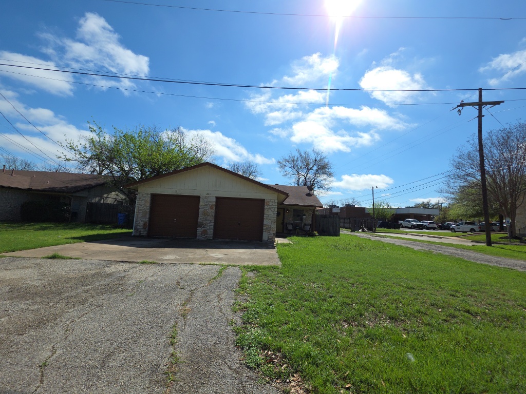 203 2nd Street North, Unit A Pflugerville, TX 78660 - Photo 24 of 25 Garage featuring driveway