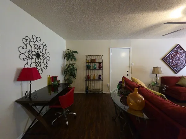 a living room with furniture and a potted plant