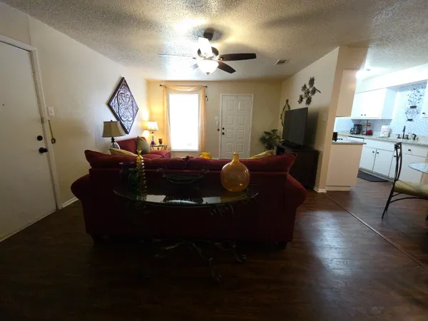 a living room with furniture and a chandelier