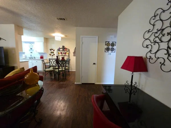 a living room with furniture and a lamp