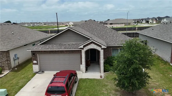a aerial view of a house with a yard and seating space