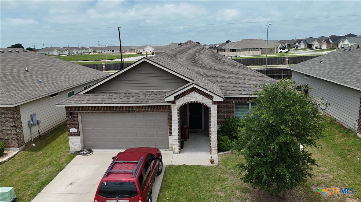 a aerial view of a house with a yard and seating space