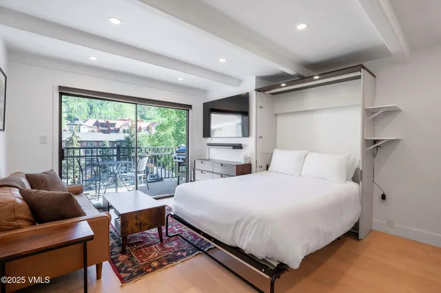 a bedroom with a bed and a large window