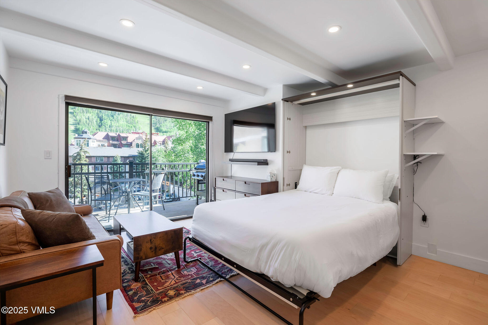 508 East Lionshead Circle, Unit 214 Vail, CO 81657 - Photo 3 of 9 a bedroom with a bed and a large window