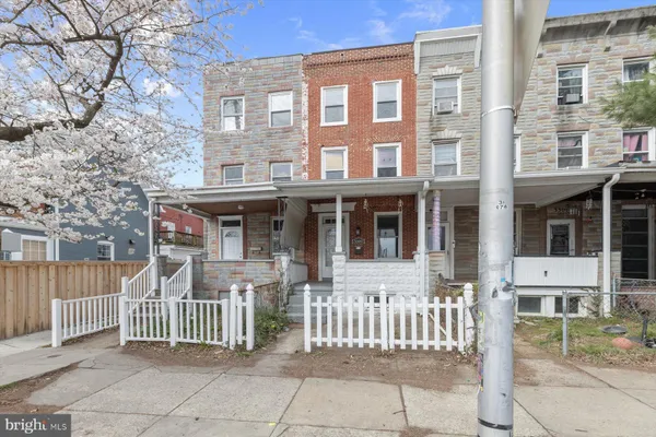 a front view of a house with a fence