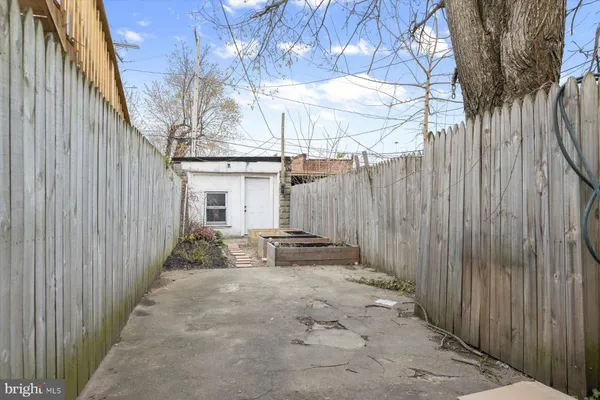 a view of a backyard with iron fence