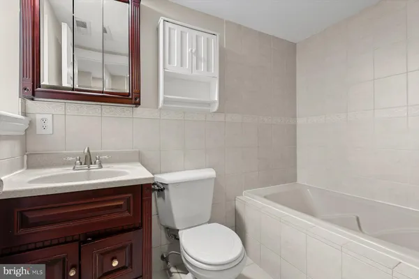 a bathroom with a sink a toilet and a bathtub