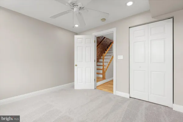 an empty room with chandelier fan