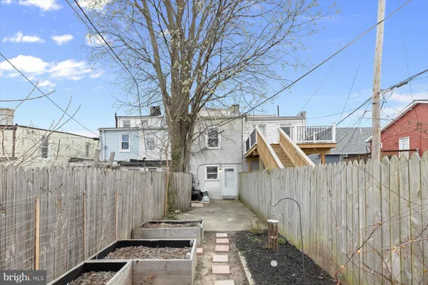 a view of a wooden house with a large tree
