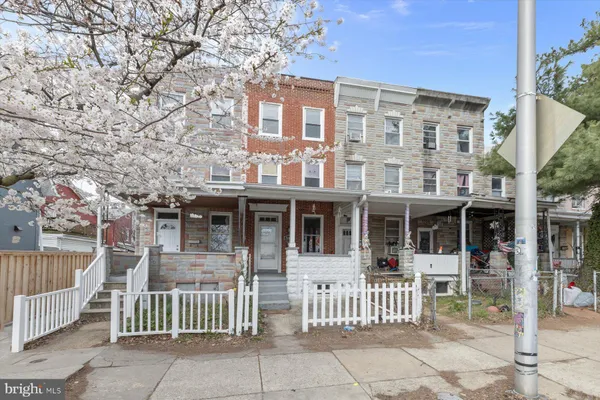 front view of a brick house with a small yard