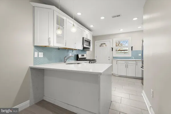 a kitchen with a sink window and cabinets
