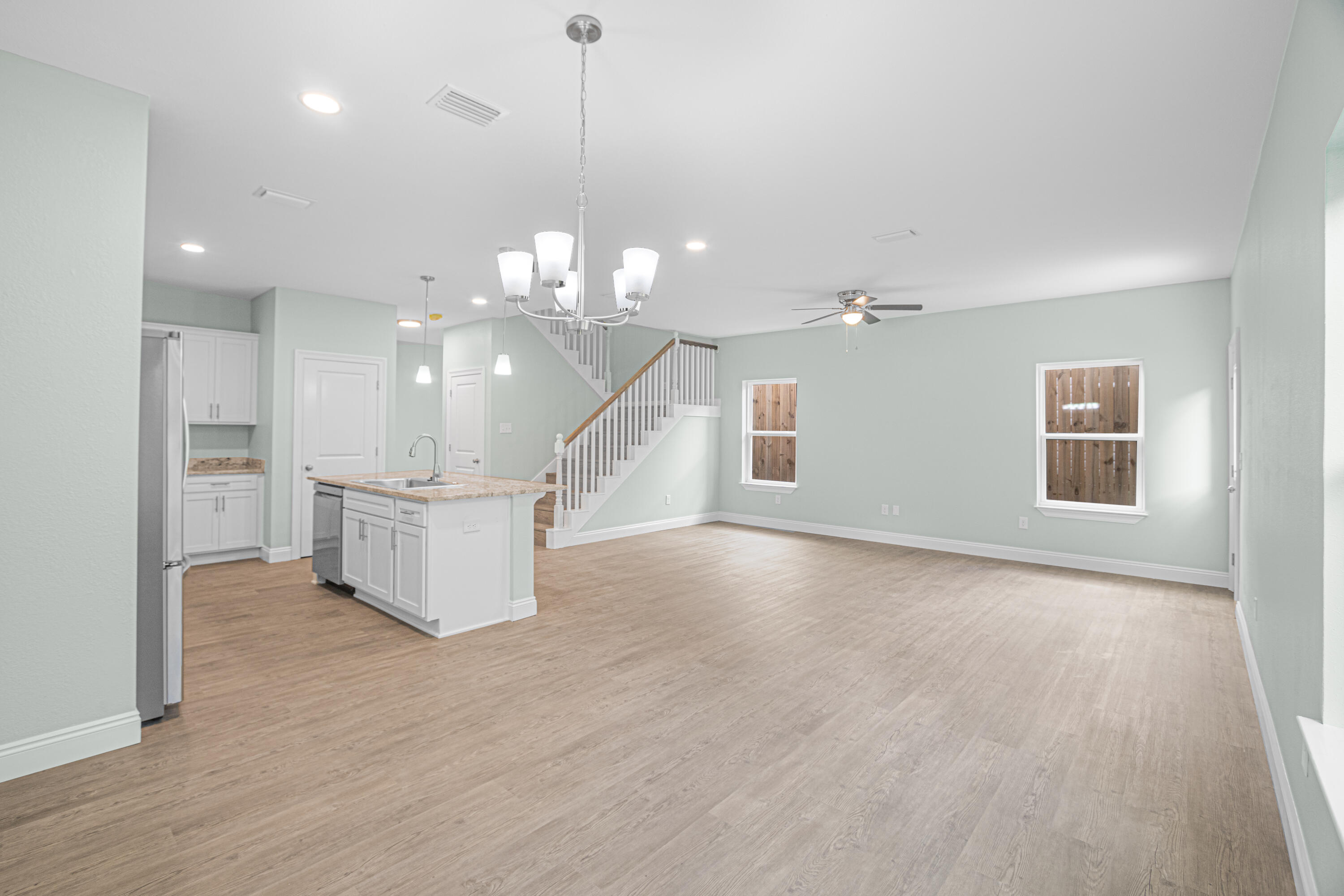 169 Johnson Court Crestview, FL 32536 - Photo 12 of 30 a view of a big room with windows and chandelier