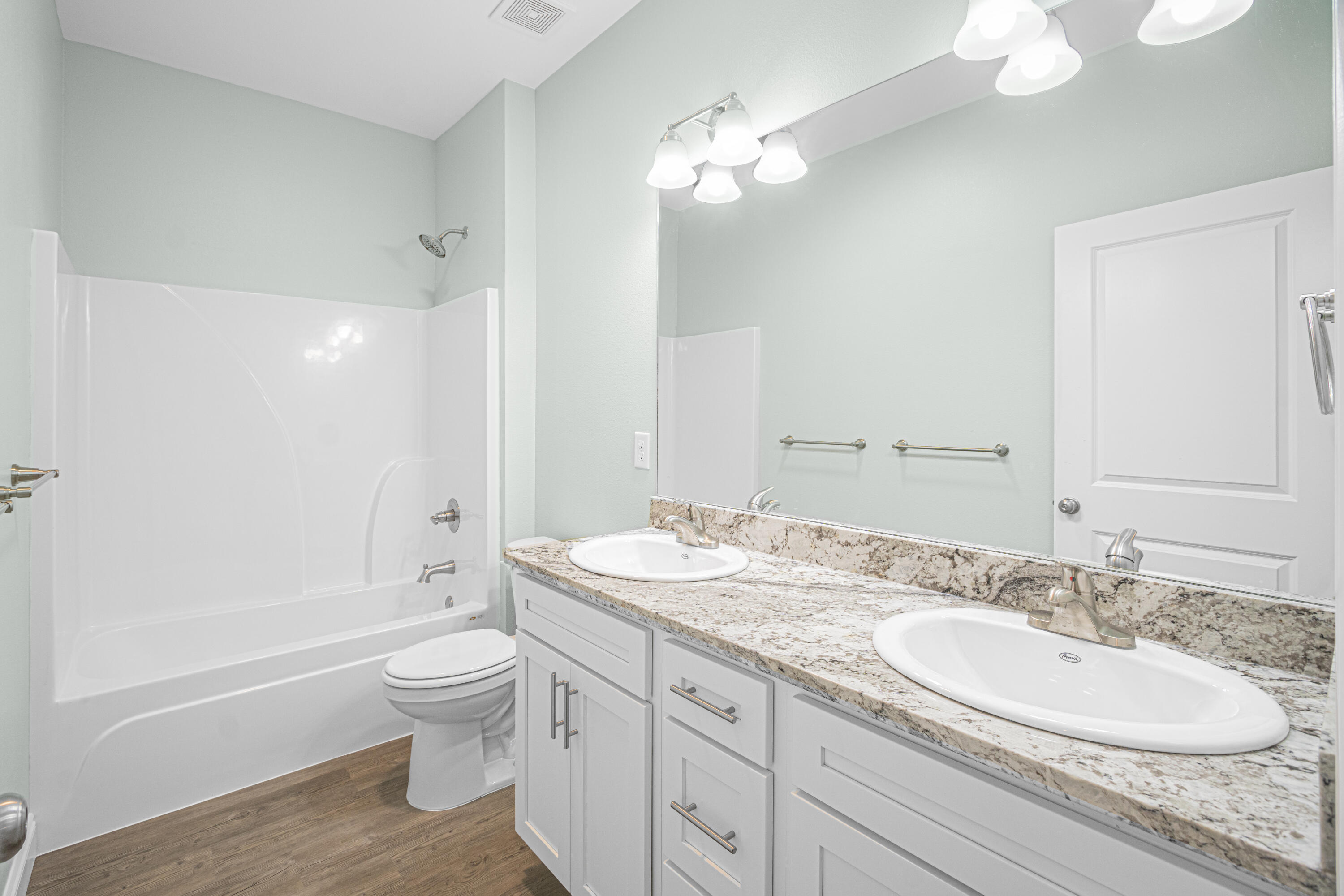 169 Johnson Court Crestview, FL 32536 - Photo 25 of 30 a bathroom with a granite countertop double vanity sink a mirror and a bathtub