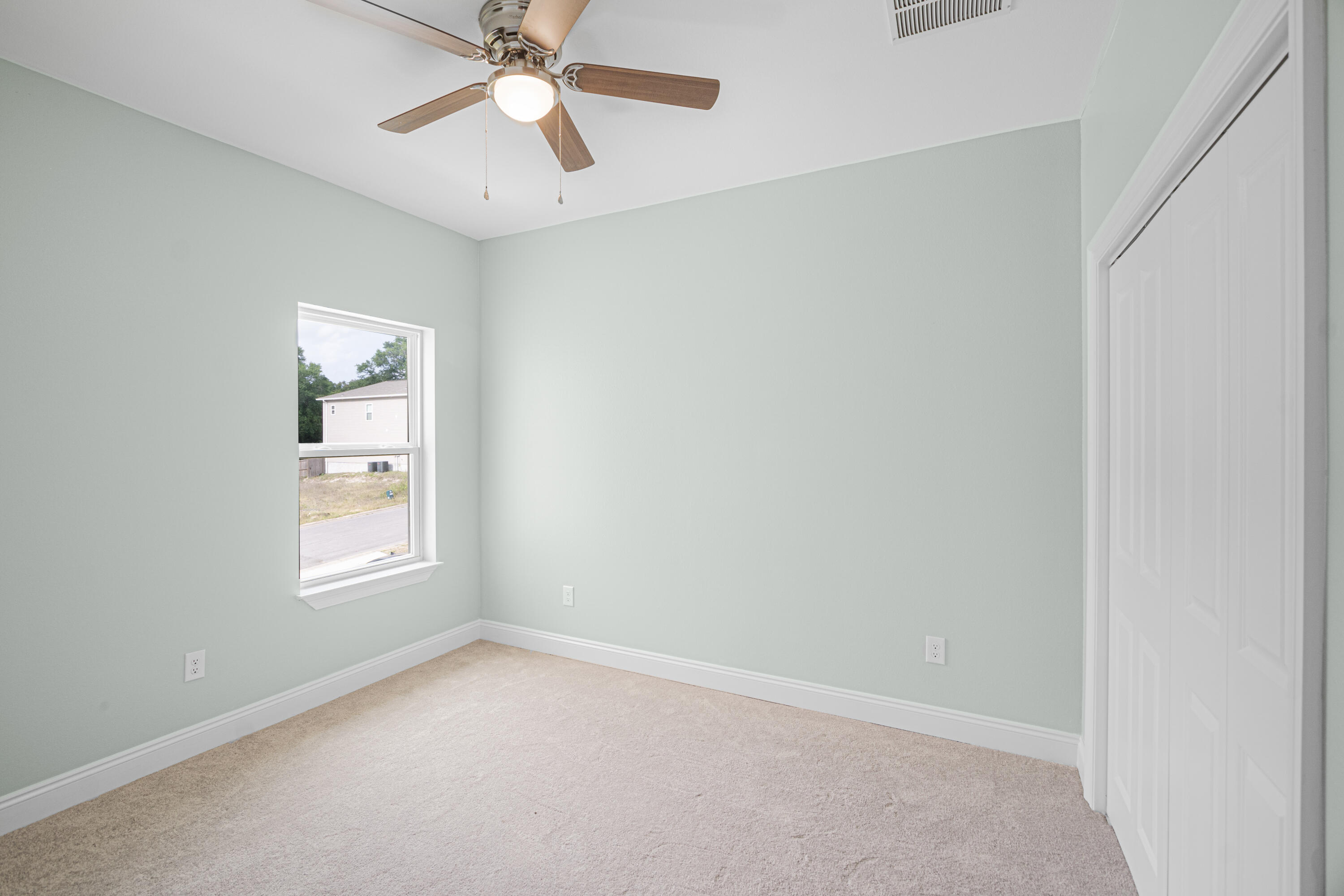 169 Johnson Court Crestview, FL 32536 - Photo 26 of 30 an empty room with a window and a fan