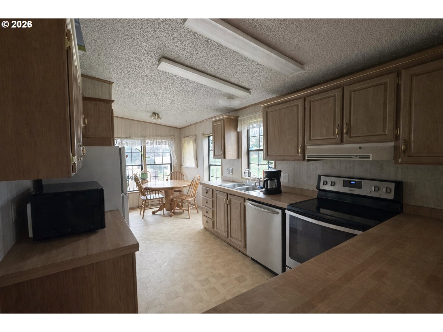 701 2nd Street Cove, OR 97824 - Photo 4 of 13 a kitchen with sink cabinets and appliances