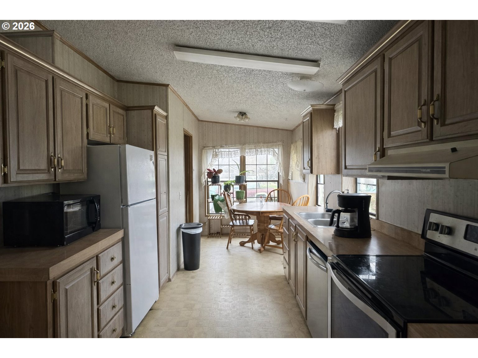 701 2nd Street Cove, OR 97824 - Photo 5 of 13 a kitchen with refrigerator cabinets and furniture