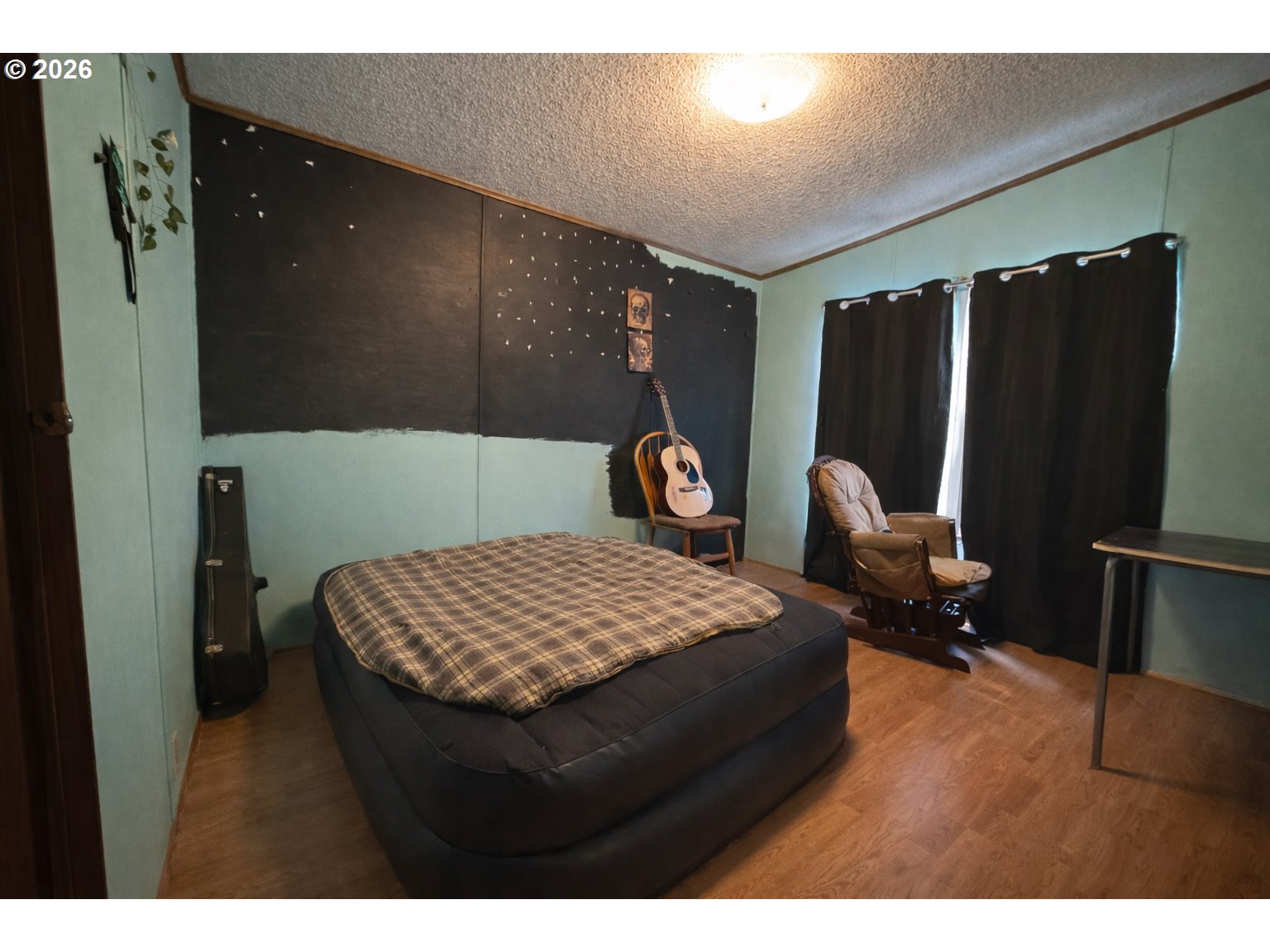701 2nd Street Cove, OR 97824 - Photo 8 of 13 a living room with a bed furniture and a flat screen tv