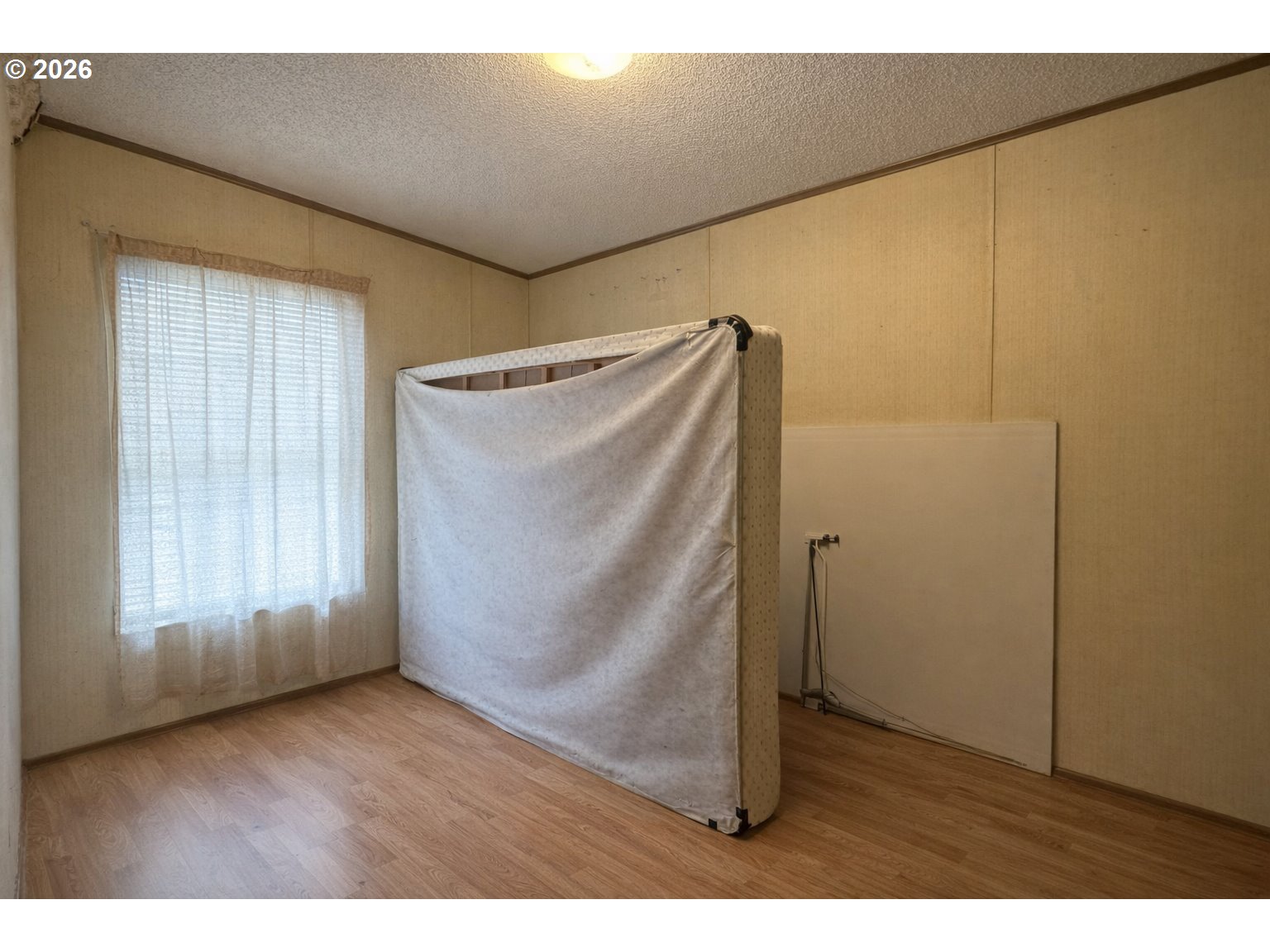 701 2nd Street Cove, OR 97824 - Photo 9 of 13 a view of an empty room with wooden floor and a window