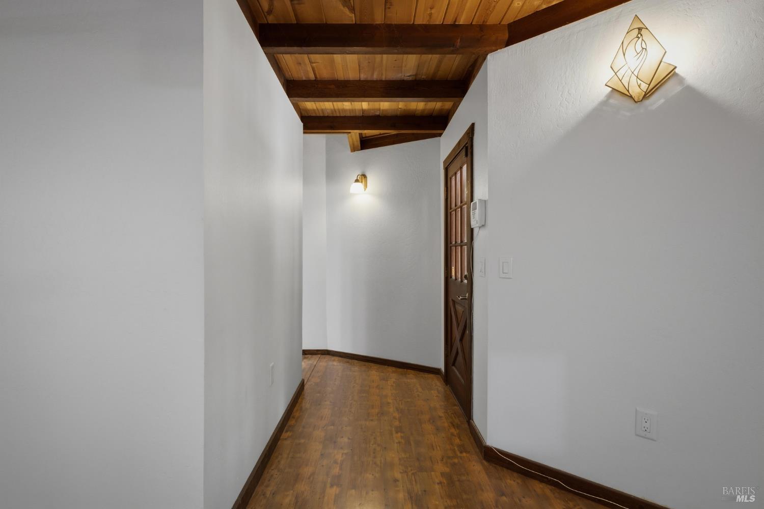 14911 Canyon 7 Road Guerneville, CA 95446 - Photo 12 of 32 a view of a hallway with wooden floor and staircase