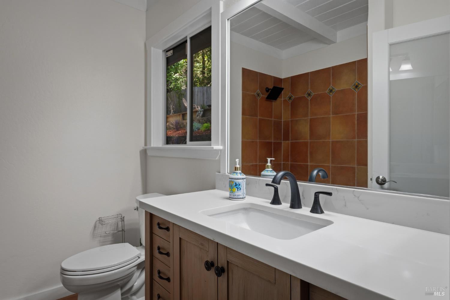 14911 Canyon 7 Road Guerneville, CA 95446 - Photo 14 of 32 a bathroom with a sink toilet vanity and window