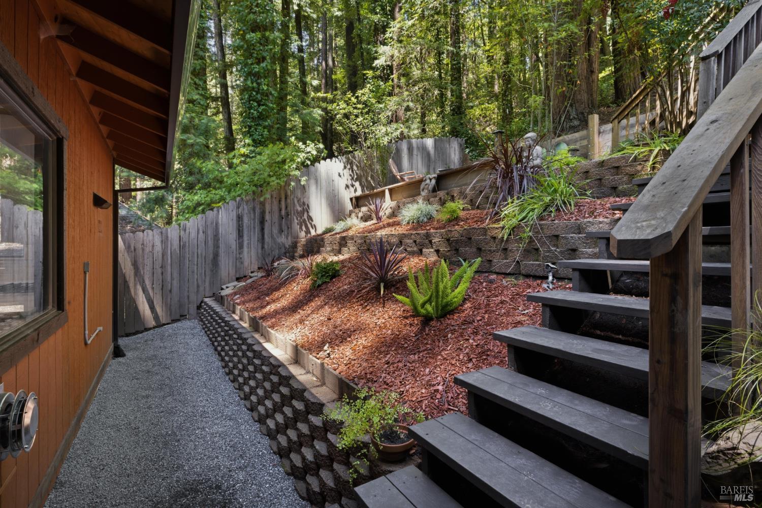 14911 Canyon 7 Road Guerneville, CA 95446 - Photo 29 of 32 a view of a house with backyard and wooden fence