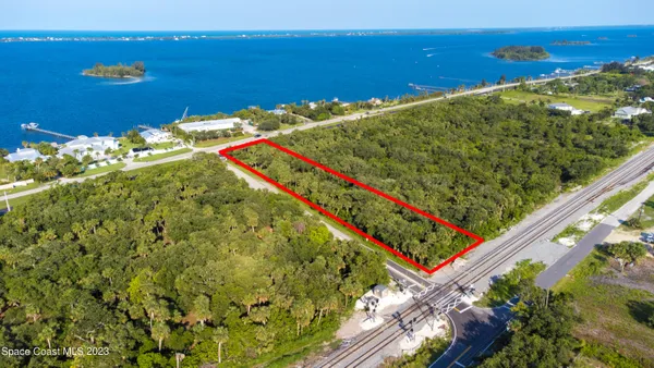 a view of a lake with a table and chairs