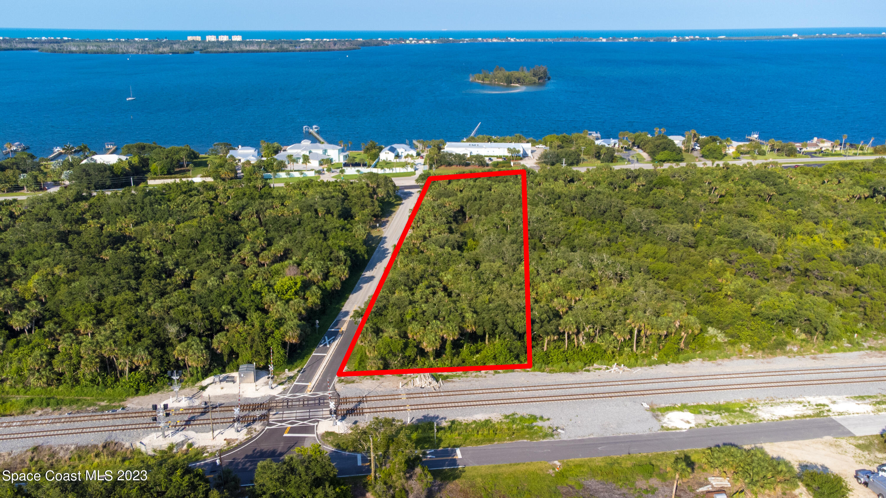 6 Shell Pit Road Grant Valkaria, FL 32949 - Photo 3 of 6 a view of a lake with a table and chairs