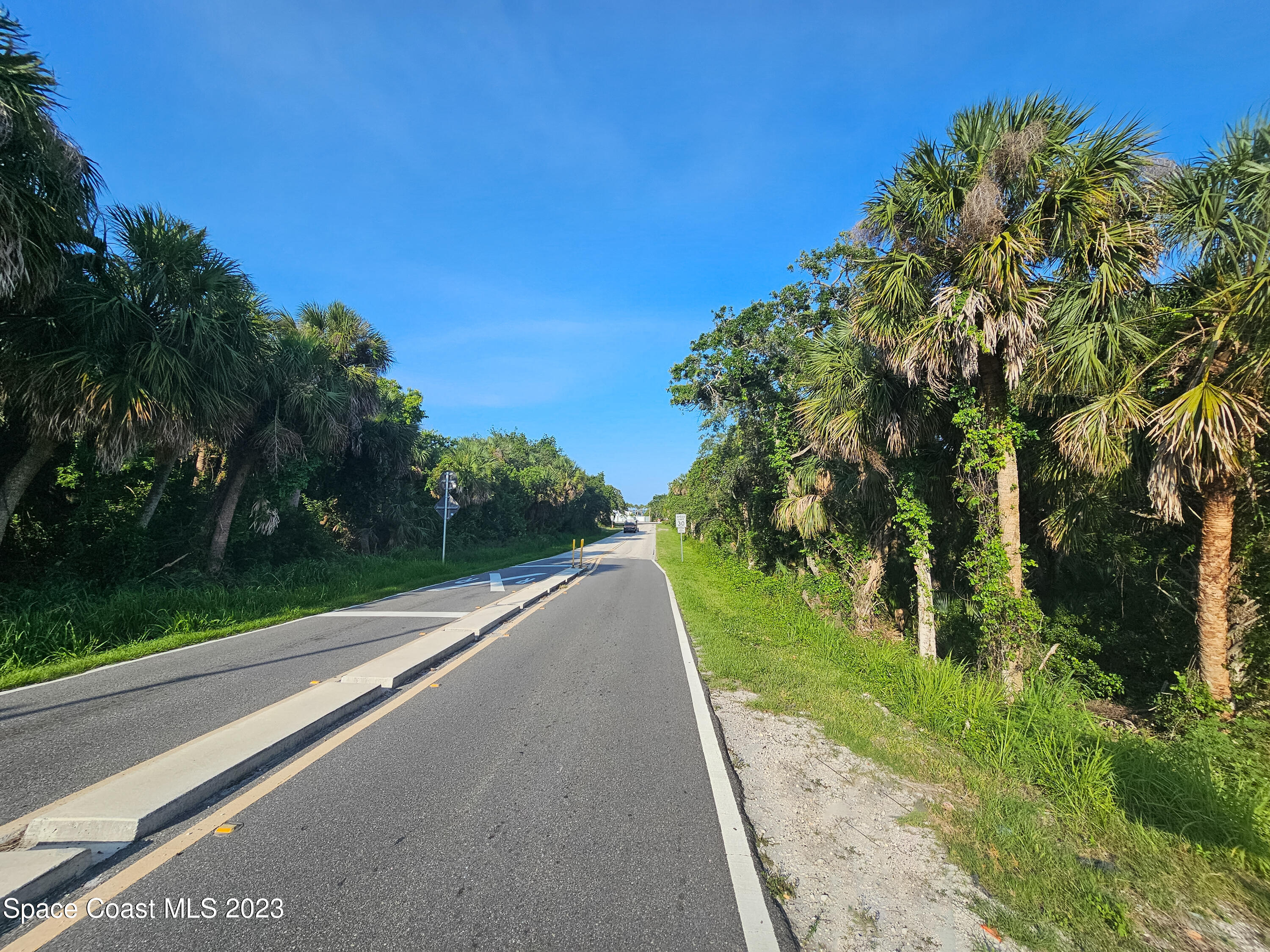 6 Shell Pit Road Grant Valkaria, FL 32949 - Photo 5 of 6 a view of a street with a yard
