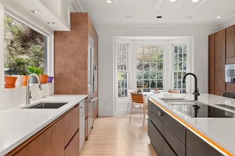 a kitchen with stainless steel appliances a sink stove and cabinets