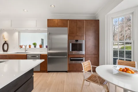 a kitchen with stainless steel appliances granite countertop a sink and a refrigerator