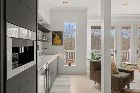 a hallway with a couch and a view of living room