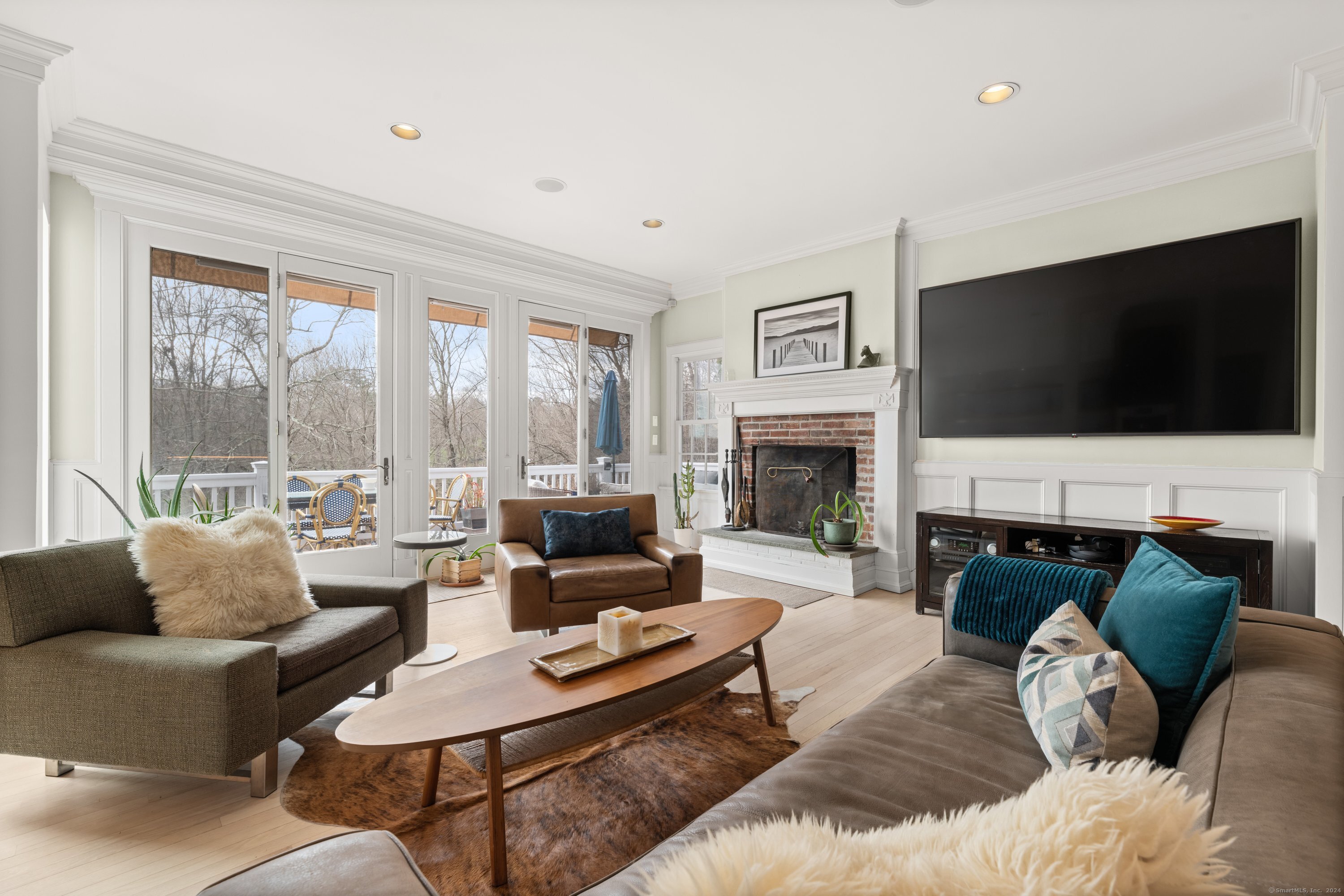 35 Branch Brook Road Wilton, CT 06897 - Photo 17 of 35 a living room with furniture a flat screen tv and a fireplace