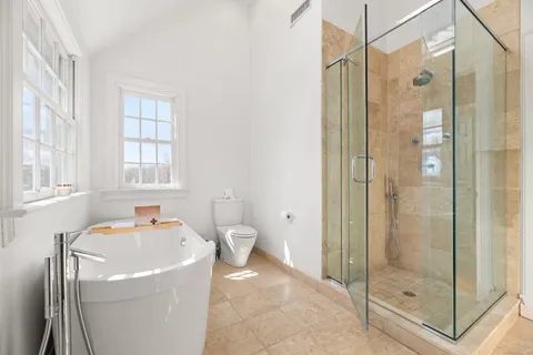 a bathroom with a tub and a shower