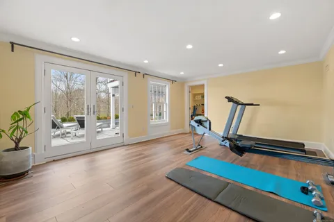 a view of a room with gym equipment and a large window