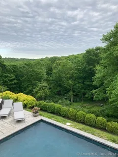 a view of a terrace with yard and mountain view in back