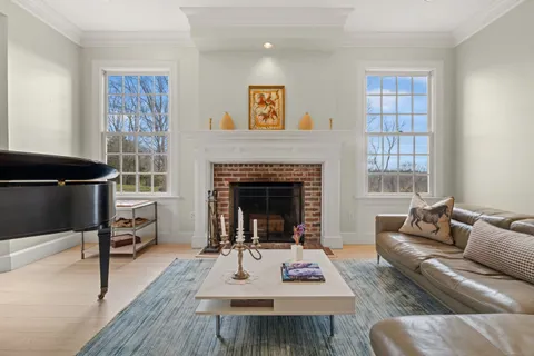 a living room with furniture a rug and a fireplace