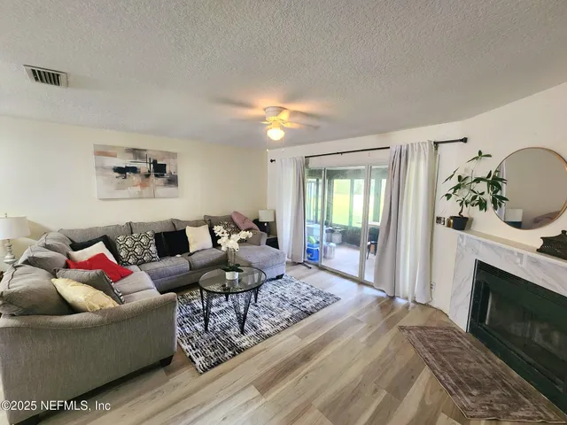 a living room with furniture and a fireplace