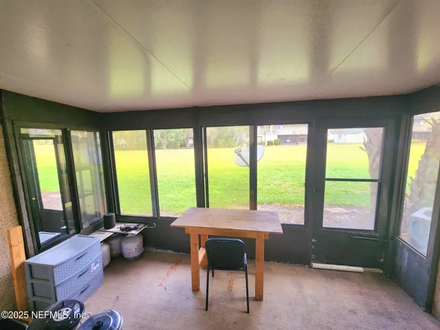 a room with furniture and large windows