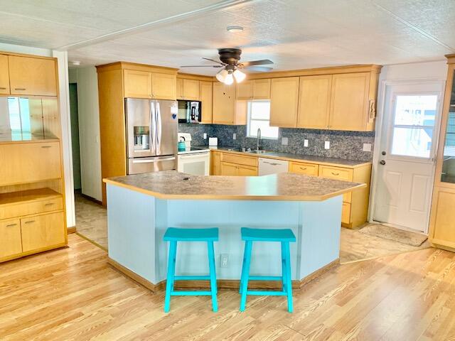 808 South Silver Circle Key Largo, FL 33037 - Photo 13 of 50 a view of a kitchen with kitchen island a large window cabinets a sink and a large window