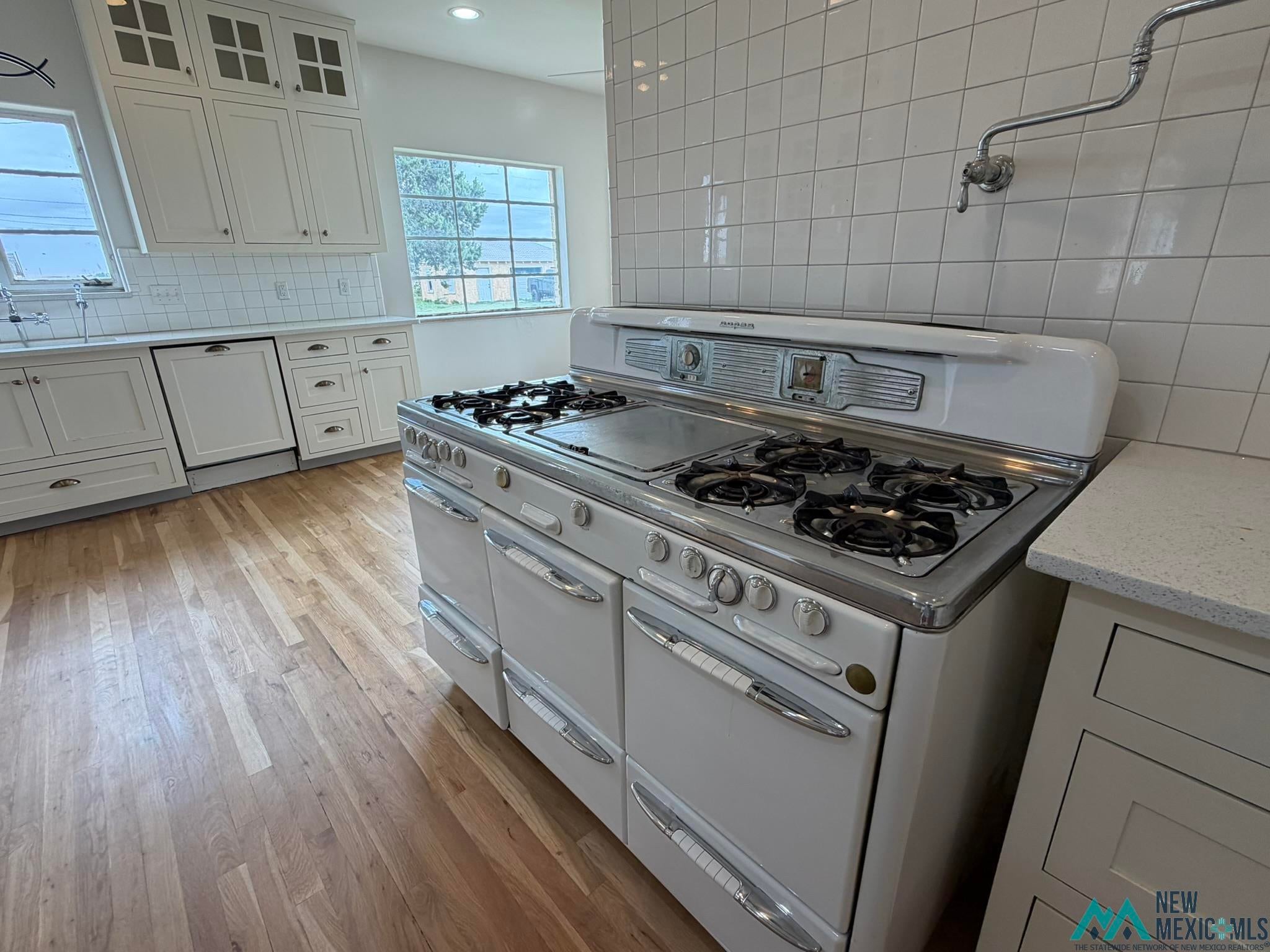 570 Curry Road North Clovis, NM 88101 - Photo 5 of 59 Kitchen featuring a white vintage-style range with six burners, a griddle, and chrome accents