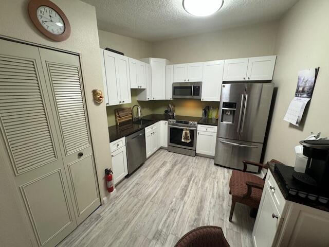 1465 Malibu Circle Northeast, Unit 101 Palm Bay, FL 32905 - Photo 12 of 25 a kitchen with stainless steel appliances granite countertop a refrigerator stove microwave and sink