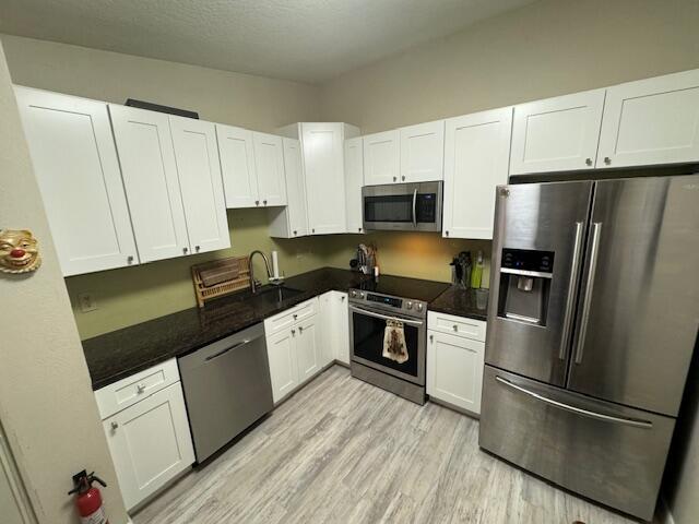 1465 Malibu Circle Northeast, Unit 101 Palm Bay, FL 32905 - Photo 13 of 25 a kitchen with granite countertop a refrigerator stove and sink