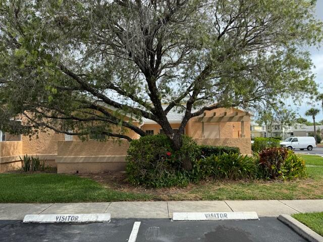 1465 Malibu Circle Northeast, Unit 101 Palm Bay, FL 32905 - Photo 3 of 25 a front view of a house with a yard