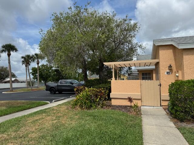1465 Malibu Circle Northeast, Unit 101 Palm Bay, FL 32905 - Photo 4 of 25 a view of a house with backyard and sitting area