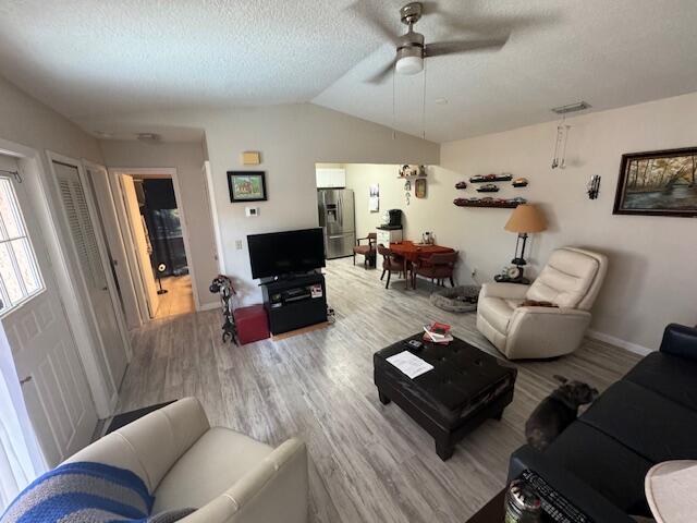 1465 Malibu Circle Northeast, Unit 101 Palm Bay, FL 32905 - Photo 9 of 25 a living room with furniture and a flat screen tv