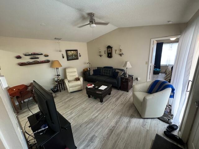 1465 Malibu Circle Northeast, Unit 101 Palm Bay, FL 32905 - Photo 10 of 25 a living room with furniture and a wooden floor