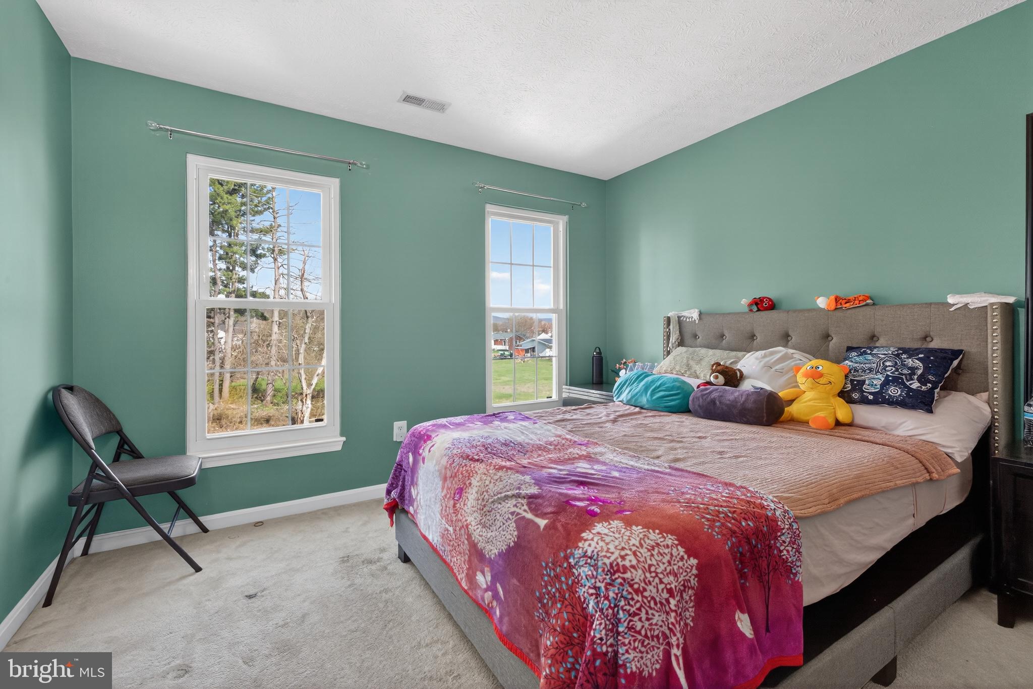 611 Hunting Ridge Drive Frederick, MD 21703 - Photo 30 of 50 a bedroom with a bed and chair