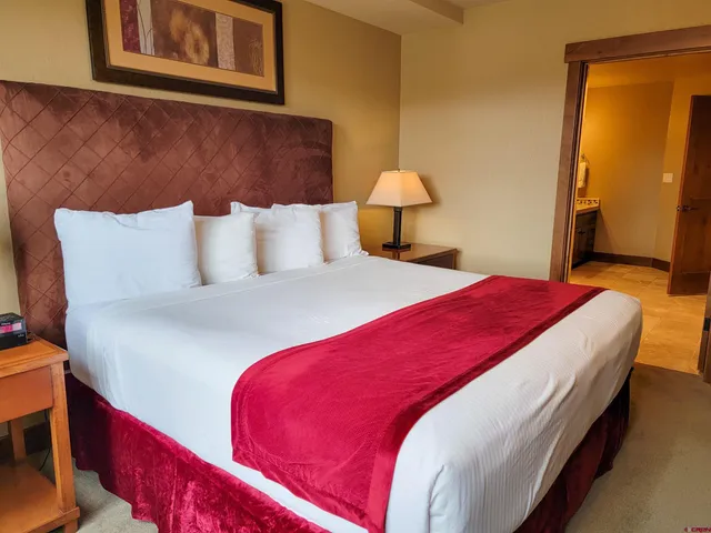 a bedroom with a bed and lamp